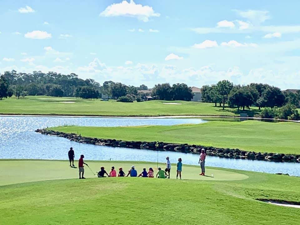 Golf clinic gathered around the green