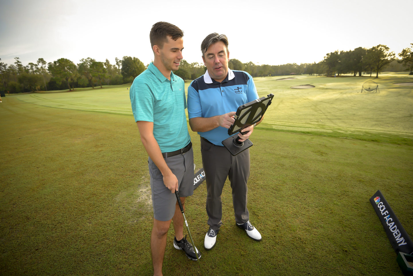 instructor teaching a golfer on the course