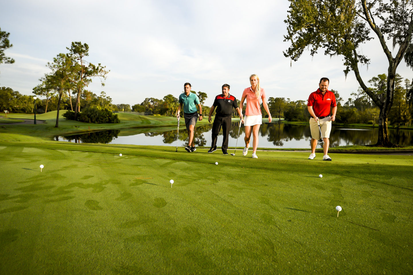 instructor and a small group walking to the tee box