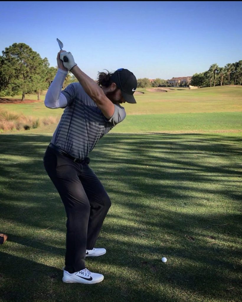 Coach Adam Andrews teeing off