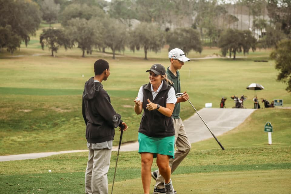 instructor engaging her golf student